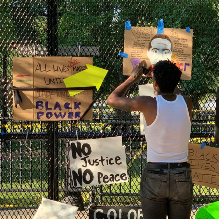 Image showing signs placed on fencing outside Lafayette Park in Washington, DC, on June 7, 2020; photo by Becky Pendergast