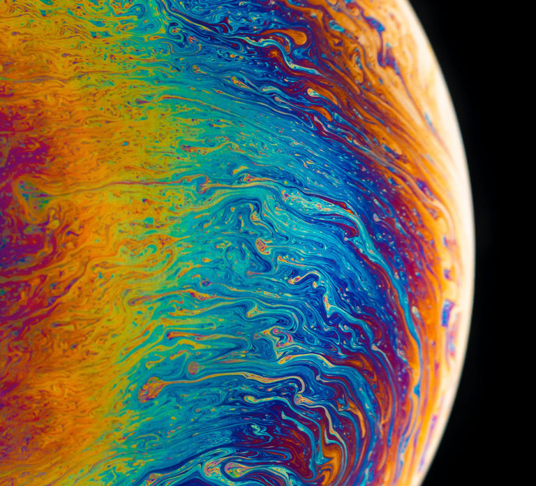 Photo illustration of a rainbow colored planet