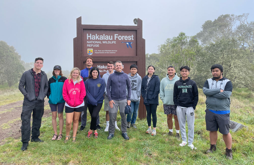 University of Hawai‘i Manoa GEO department students and faculty stop to pose for a photo at at Hakalau Forest National Wildlife Refuge, near Hilo, Hawai'i. (Courtesy David Beilman)