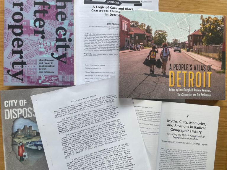 A photo of several papers and books about Detroit arranged on a desktop. Credit: Patricia Ehrkamp