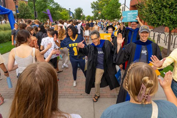 Drs. Faulkner and Hilgendorf greeting 1st year students on the first day of classes at UWEC.