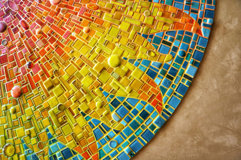 Colorful tiles form a mosaic of a sun; Credit: Emily Jackson, Unsplash